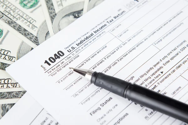 Tax forms with dollar bills — Stock Photo, Image