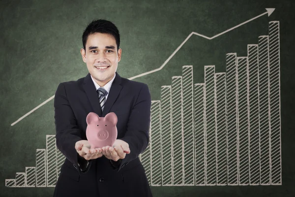 Businessman holding a piggy bank — Stock Photo, Image