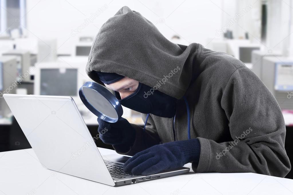 Hacker looking for information at office