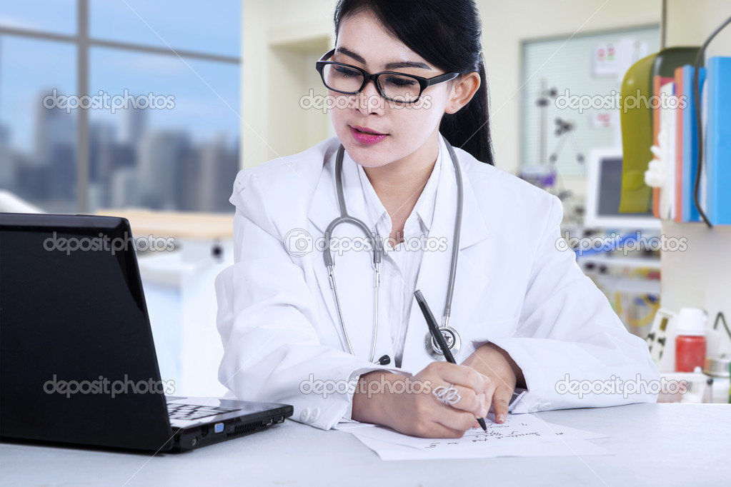 Female doctor writes a prescription