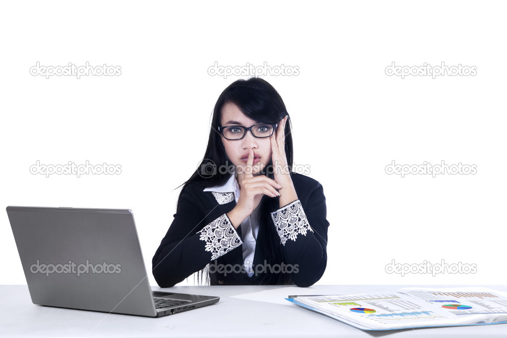 Businesswoman making silence gesture