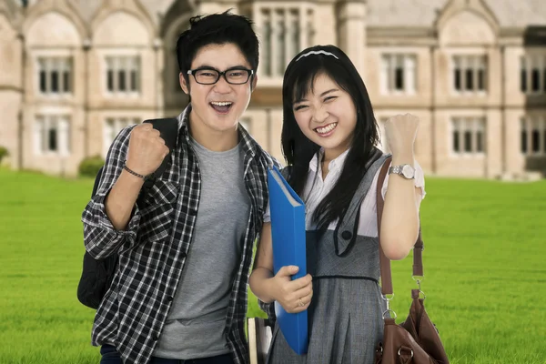 Attractive students expressing success outdoor