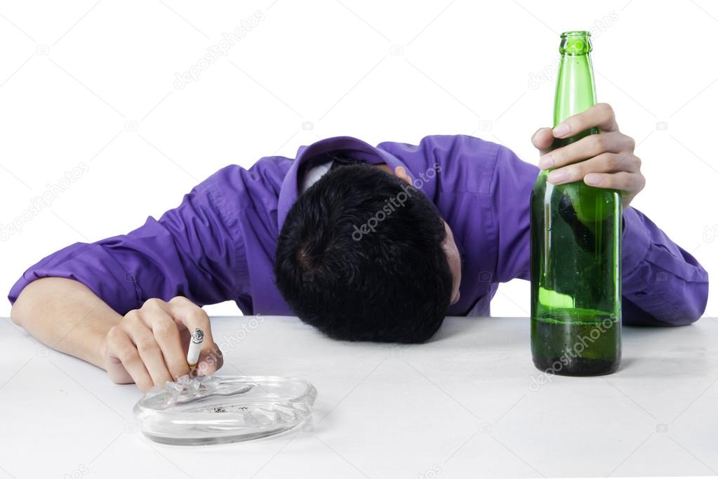 Drunk man holding cigarette and bottle of beer