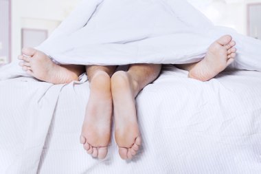 Pairs of feet in a bed 1 clipart