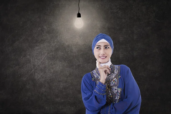 Asian female muslim under lit bulb in class — Stock Photo, Image