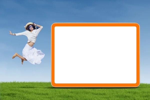 Woman jumping next to empty board — Stock Photo, Image