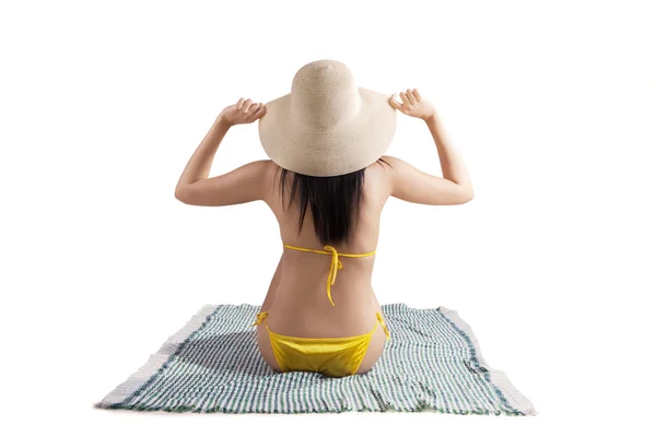 Sexy woman wearing bikini sitting on mat — Stock Photo, Image