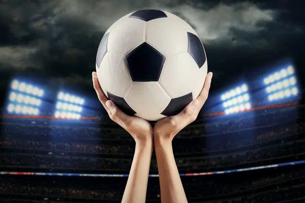 Hands holding soccer ball at stadium 1 — Stock Photo, Image