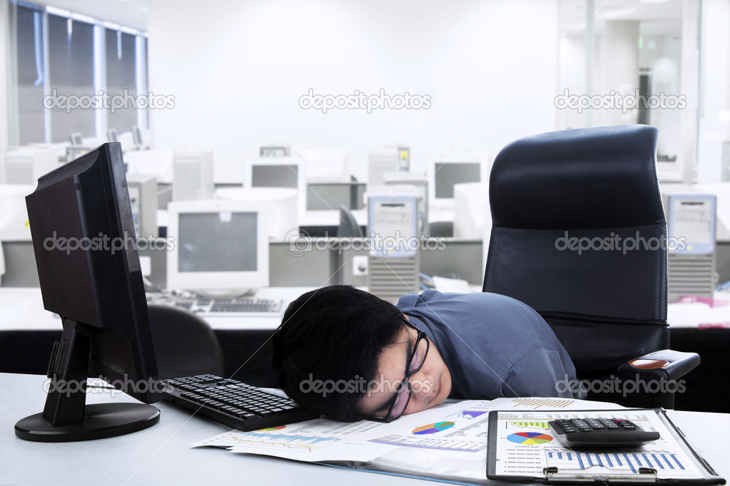 Tired businessman sleeping on the desk
