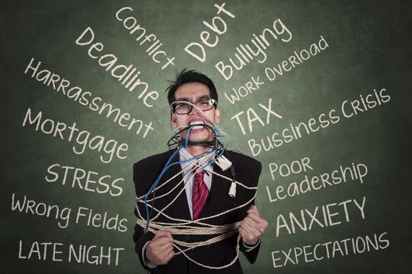 Anger businessman tied with a rope 1 — Stock Photo, Image