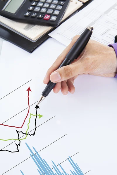 Businessman examining financial charts — Stock Photo, Image