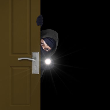 Burglar sneaking through door clipart