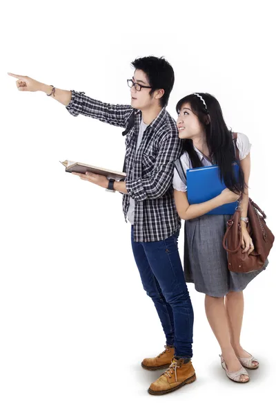 Students pointing and looking at copyspace — Stock Photo, Image