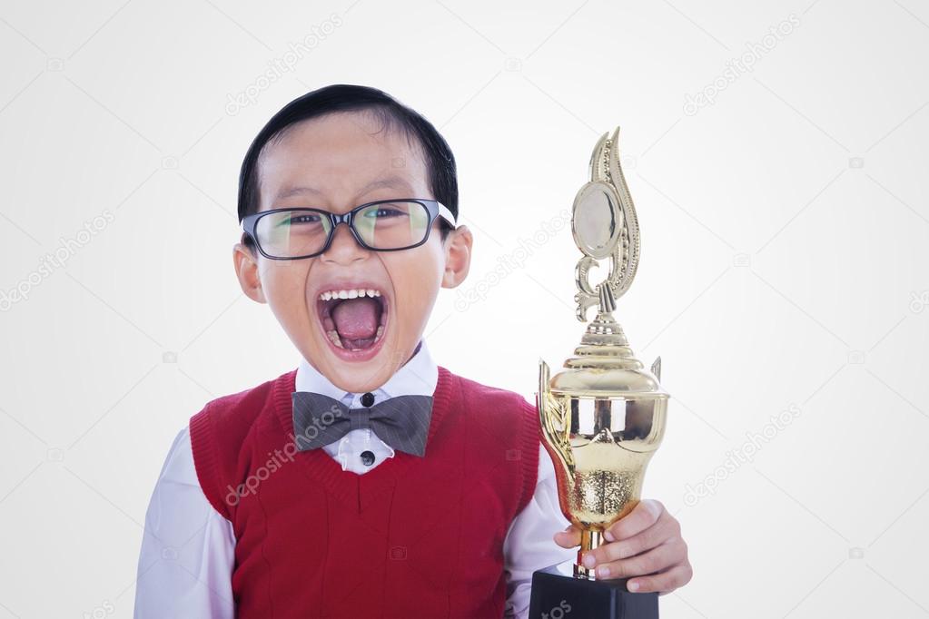 Excited student boy holding trophy - isolated