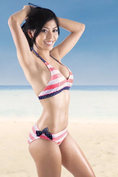 Asian woman wearing striped bikini — Stock Photo, Image