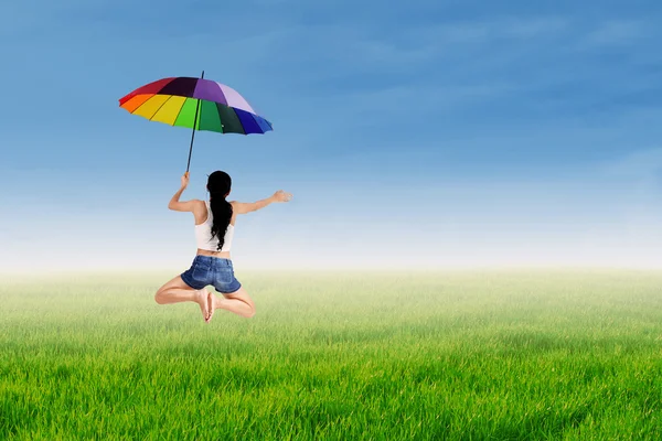 Girl jumping with an umbrella — Stock Photo, Image