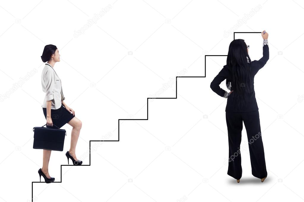Businesswoman stepping up on stairs to success