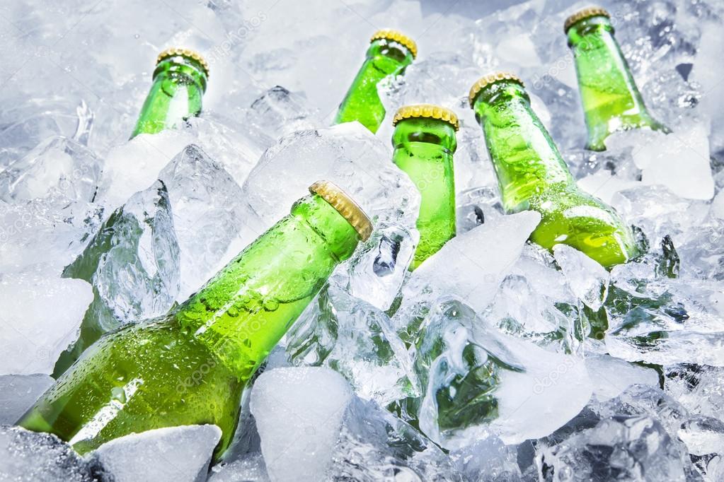 Cold beer bottles on ice — Stock Photo © realinemedia 47293631