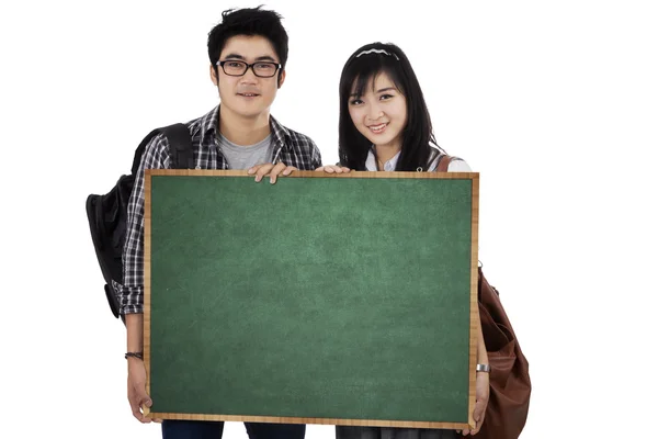 Two student holding empty blackboard 1 — Stock Photo, Image