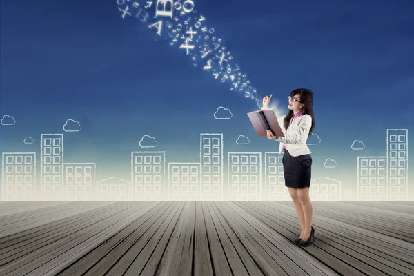 Businesswoman with flying alphabet — Stock Photo, Image