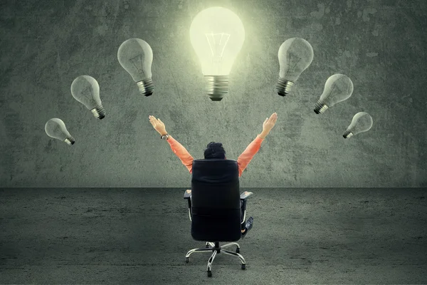 Successful businessman under lightbulb — Stock Photo, Image