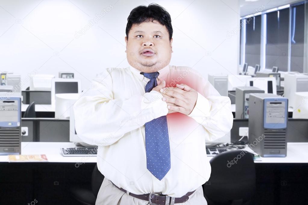Obesity businessman getting heart attack