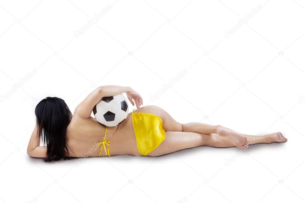 Rearview of sexy woman with ball isolated