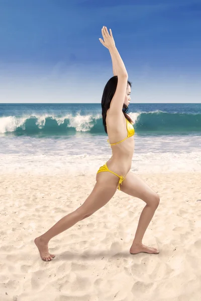 Young woman in swimsuit meditating — Stock Photo, Image