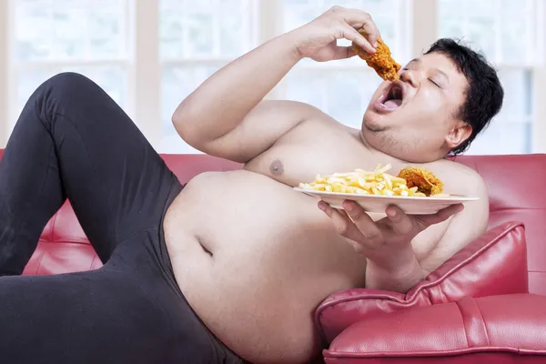Fat man eats junk food 1 — Stock Photo, Image