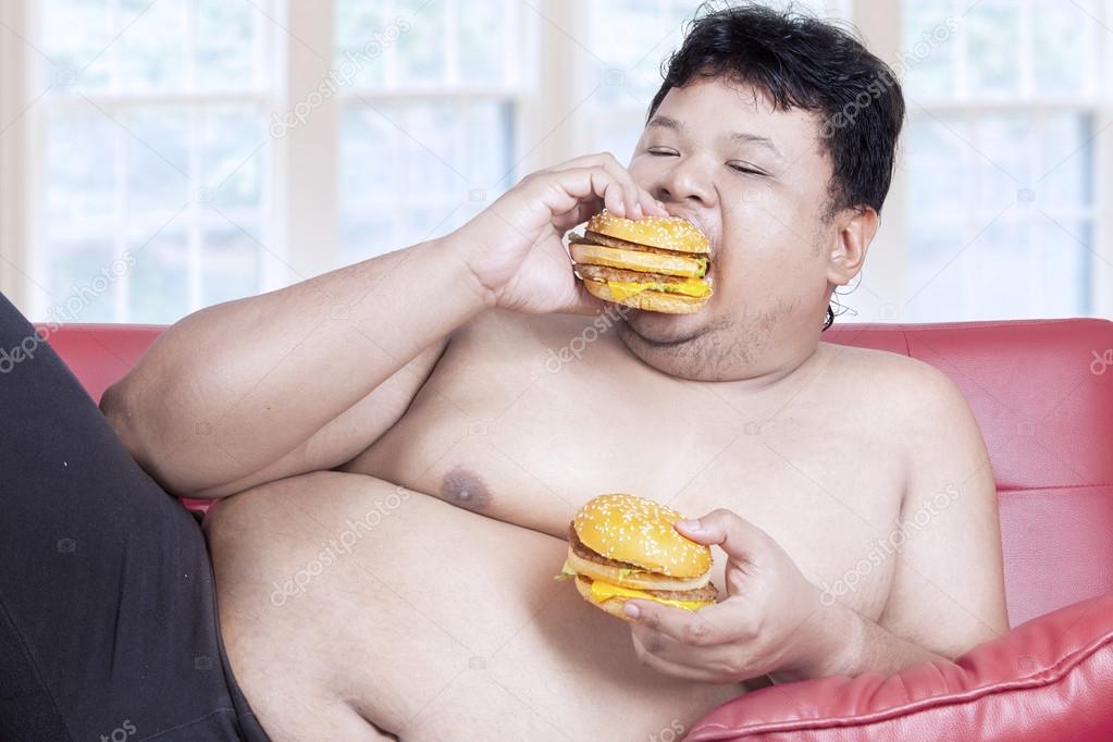 Fat man eats two hamburgers 1