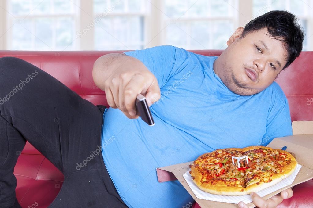 Man eats pizza while watching tv 2