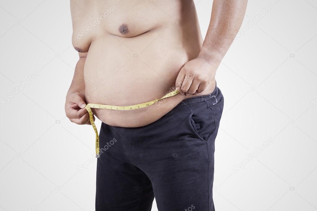 Obese person measuring his belly 2