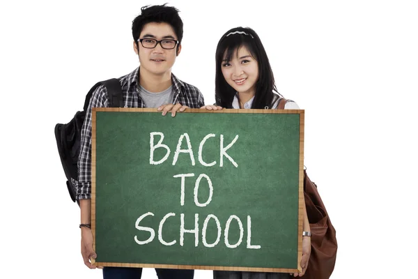 Två student håller små blackboard 1 — Stockfoto