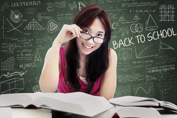 Beautiful female college student in class — Stock Photo, Image