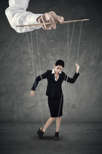 Businesswoman hanging on string