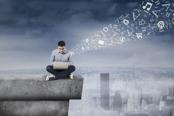 Man using laptop on rooftop 1 — Stock Photo, Image