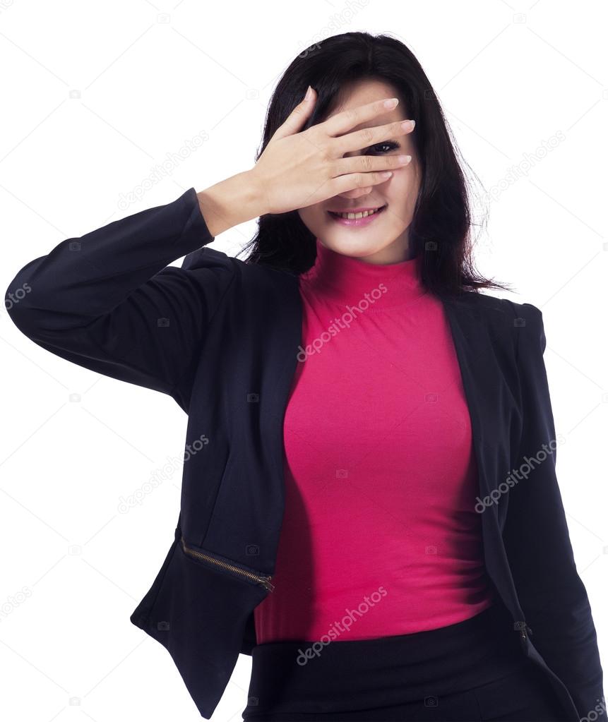 Businesswoman peeking from fingers