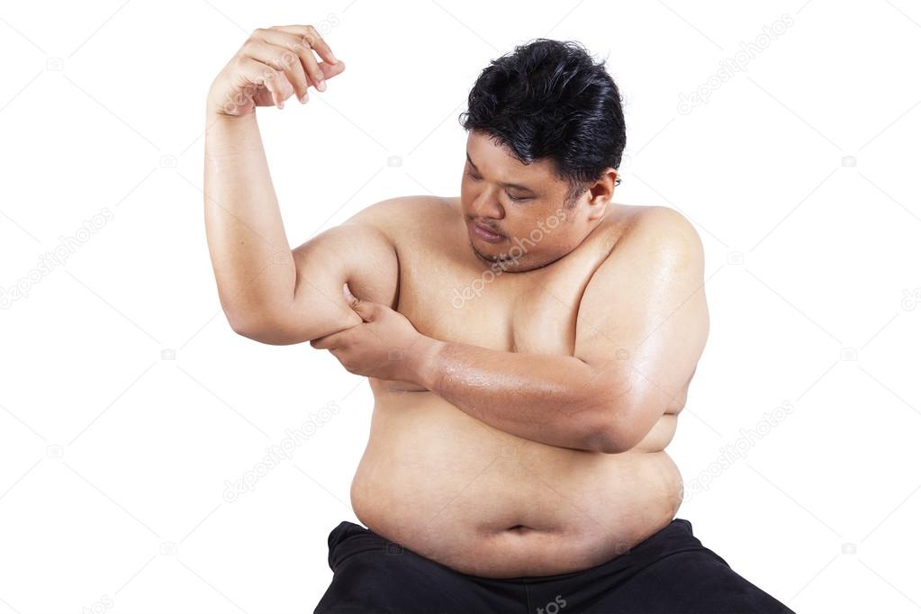 Fat man holding his flabby biceps 1
