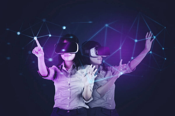 Young woman using a virtual glasses while playing in the metaverse with connection network background