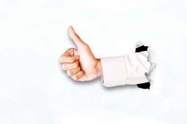 Yırtılan kağıtların arasından işadamının elinin baş parmağını göstermesi. Beyaz arkaplanda izole