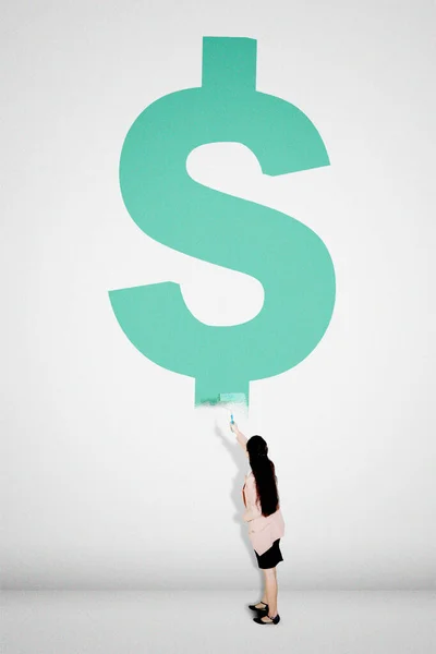 Rear View Businesswoman Holding Roller While Painting Dollar Symbol Wall — Stock Photo, Image