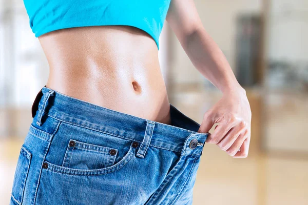 Close Young Woman Showing Slim Belly While Trying Her Old — Stock Photo, Image