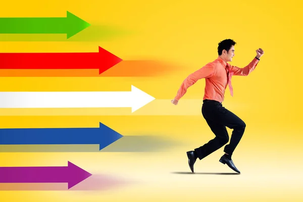 Side View Businessman Running Race Colorful Arrows Studio Yellow Background — Stock Photo, Image