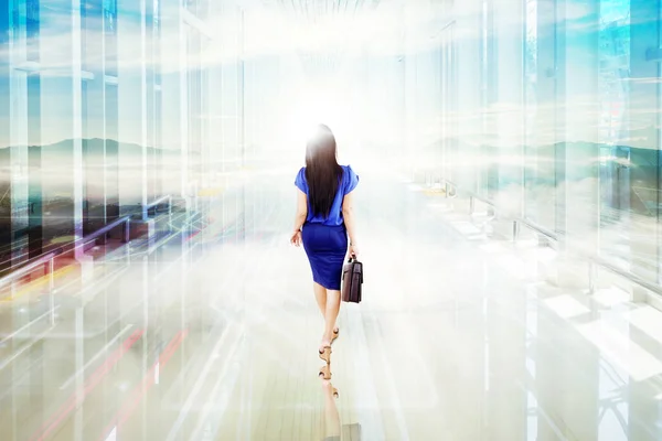 Widok Tyłu Businesswoman Niosące Walizkę Podczas Spaceru Kierunku Jasnego Światła — Zdjęcie stockowe