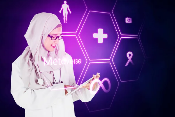 穆斯林女医生站在网络空间时使用数字平板电脑 带有不同的符号 — 图库照片