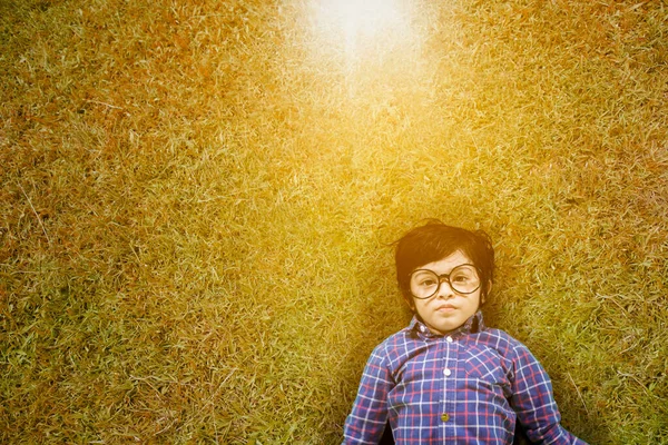 Top View Little Boy Wearing Glasses While Lying Green Grass — Stok fotoğraf