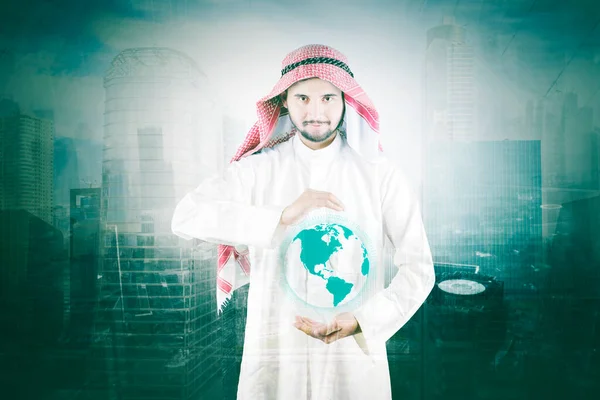 Double Exposure Arabian Businessman Holding Virtual Globe Cyberspace While Standing — стоковое фото
