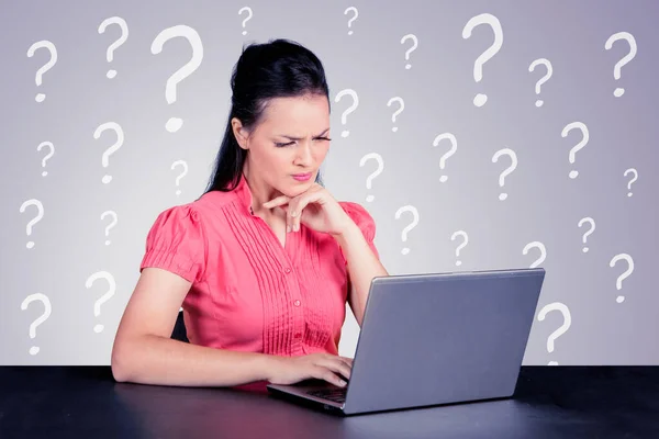Confused Businesswoman Working Laptop While Sitting Question Mark Symbol Background — стоковое фото