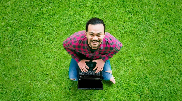 Top View Male College Student Using Laptop While Sitting Green — Zdjęcie stockowe