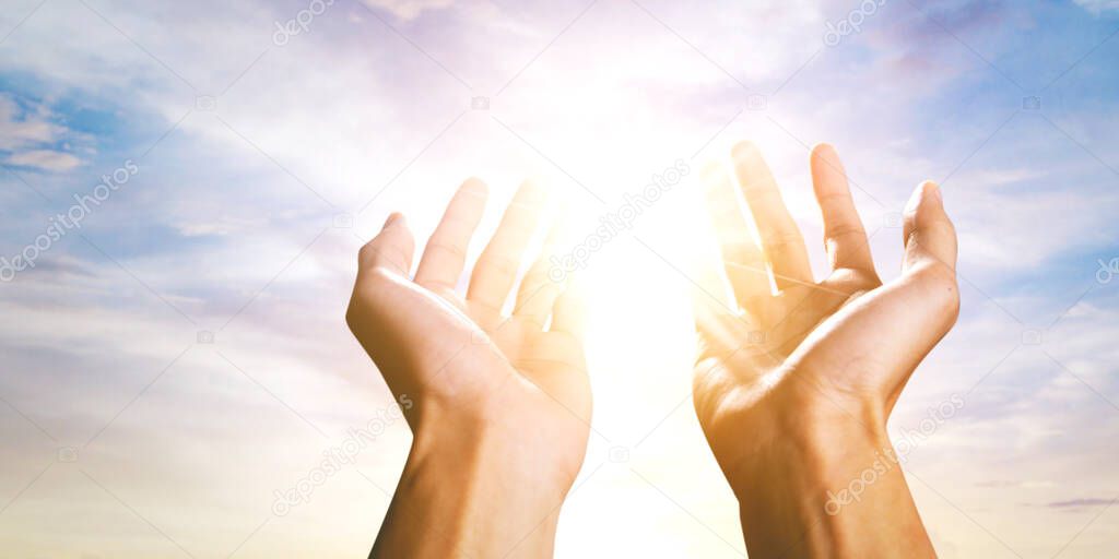 Close up of Muslim man hands lifting toward the sky while praying to the Allah